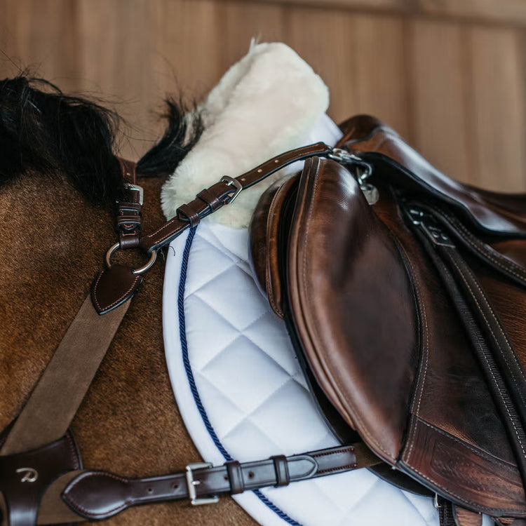 White jumping saddle blanket with sheepskin underside