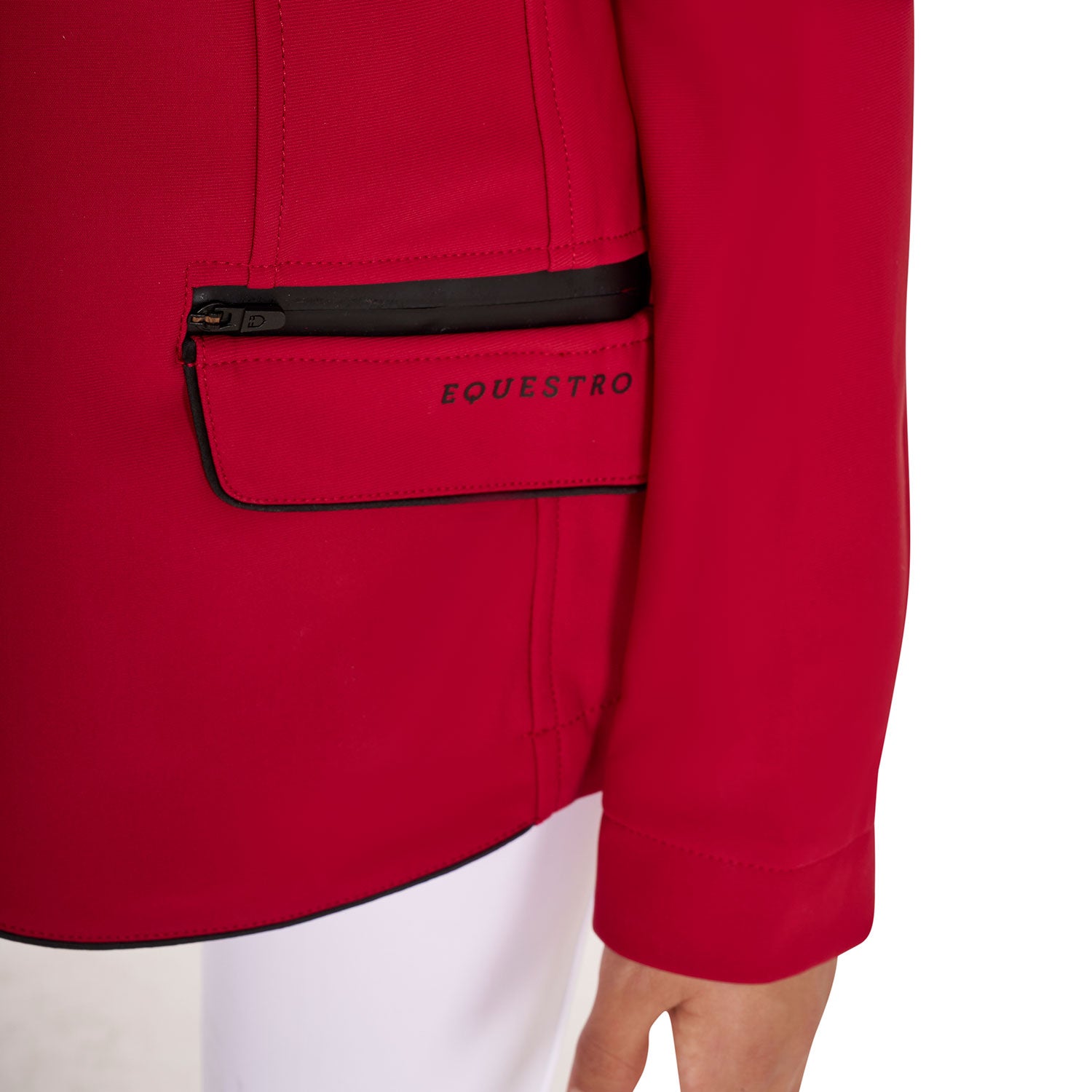Close up of pockets on girls red show jumping jacket