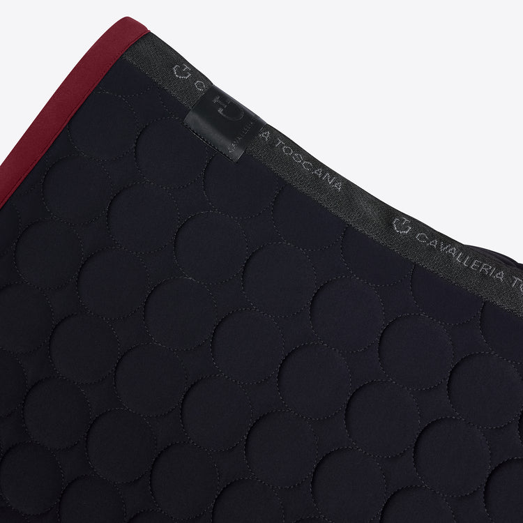 Close up of CT black saddle pad with dark red edging