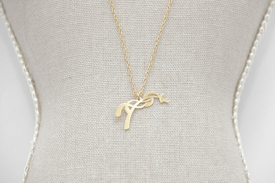 Penelope Angele gold horse pendant necklace with a discreet feminine look.