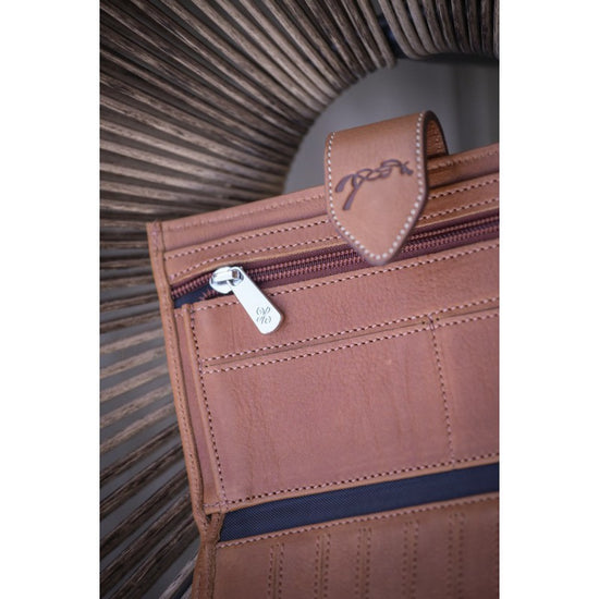 Penelope Bertille perforated leather wallet with multiple compartments.