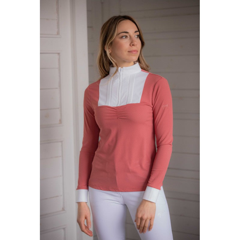 Lady equestrian wearing Penelope long sleeve show shirt in pale pink with perforated fabric and white bib