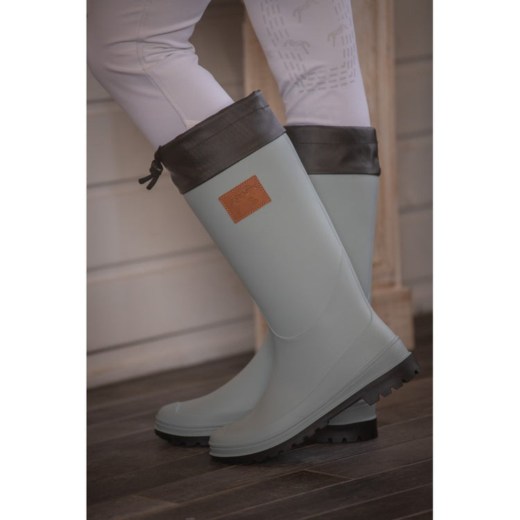 Penelope Jessica waterproof boots in Light Green with black drawstring cuff, lugged sole and logo details.