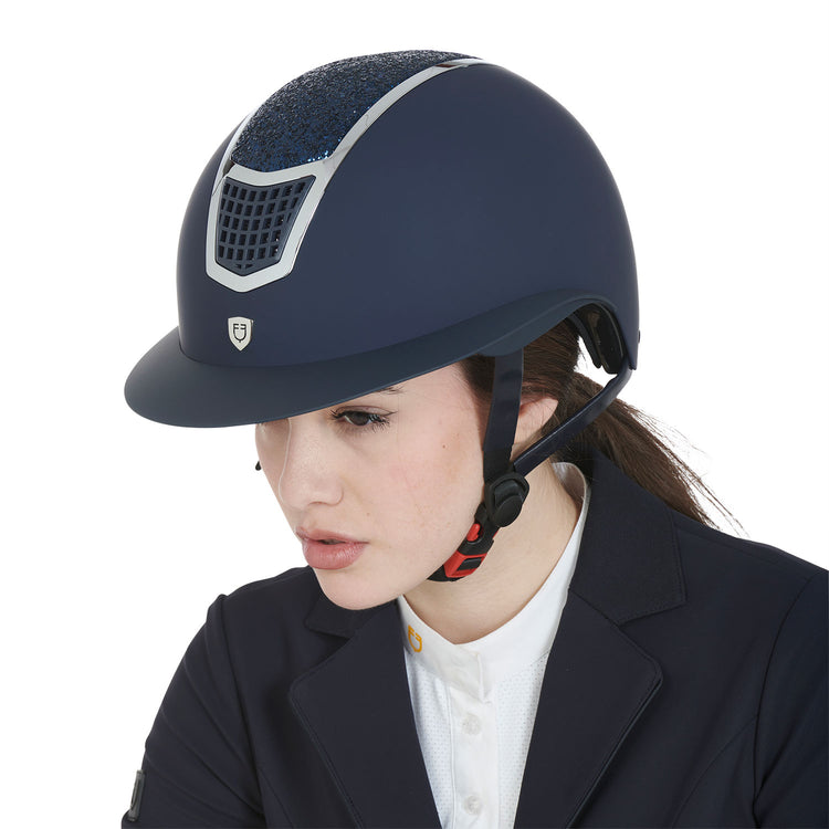 Female equestrian wearing a navy horse riding helmet
