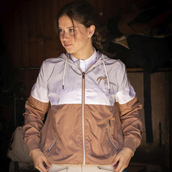 Penelope Celecce water-repellent jacket with large adjustable hood and zipped pockets.
