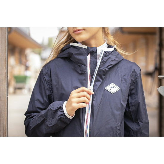 Penelope long rain coat for riding with coverage over the rider’s body and legs.