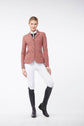 Woman wearing a pink Vestrum riding jacket and white breeches