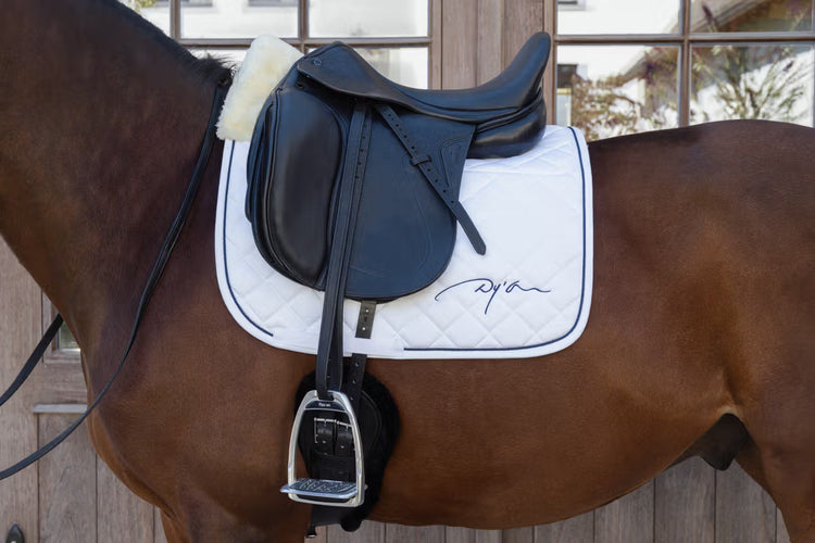 White dressage saddle pad with sheepskin