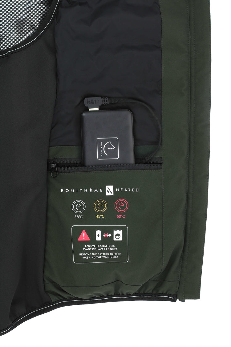 Close-up of a heated jacket with battery and control panel details 