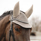 Horse wearing a beige fly bonnet