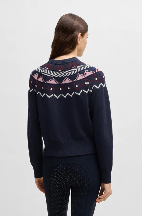 Lady wearing a BOSS equestrian winter cardigan in navy blue with pink norwegian print