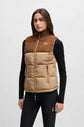 Woman wearing a two-tone brown and beige puffer vest