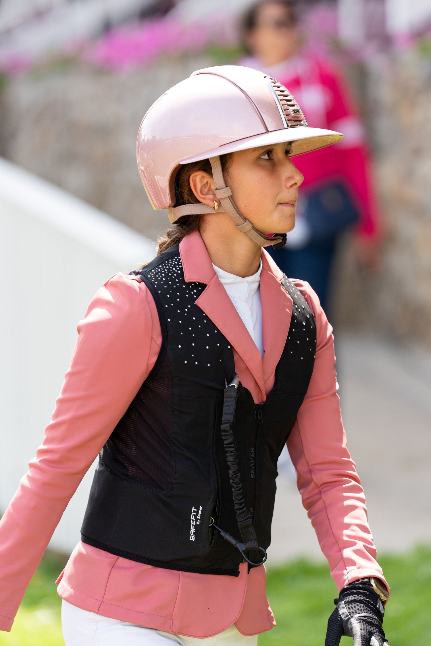Lady wearing a pink show jacket with pink Kep Italia helmet and Seaver Crystal Rain airbag vest