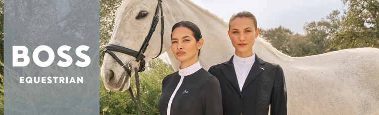 Two equestrians wearing BOSS Equestrian competition clothes next to a white horse