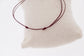 Adjustable horse logo bracelet with fine cord and elegant gold-plated detail.