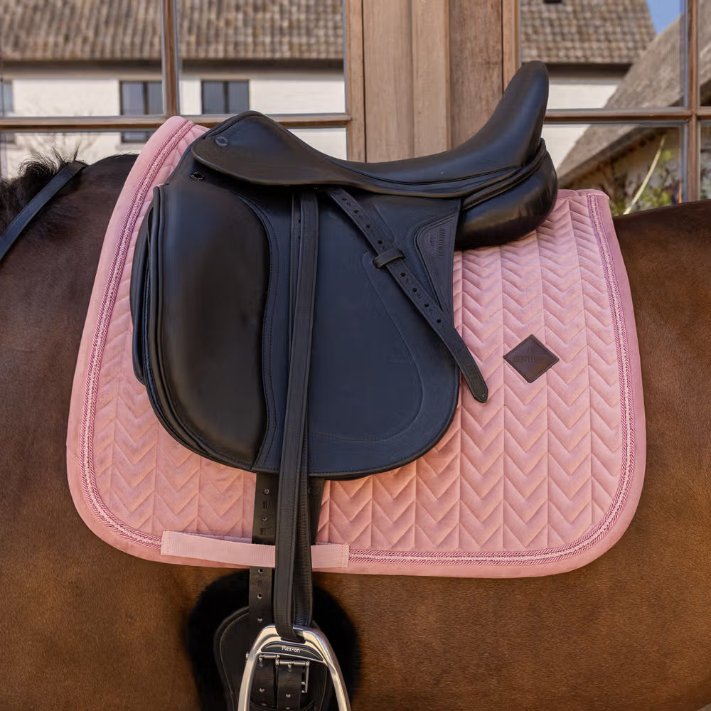 Anatomical dressage saddle pad with girth strap for a practical fit.