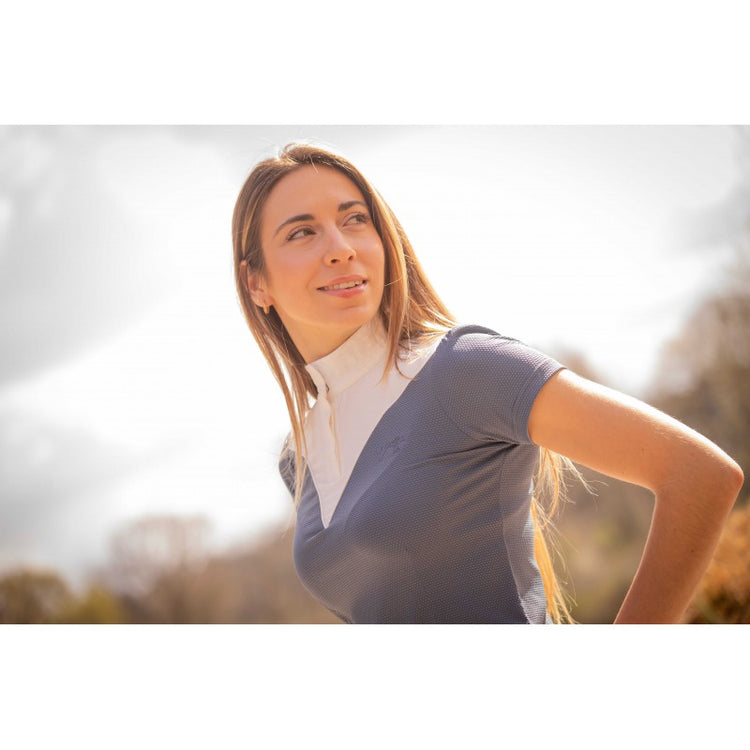 Breathable equestrian competition shirt with lightweight technical fabric for comfortable riding.
