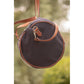 Canvas travel bag with leather handles and shoulder strap for versatile carrying options.