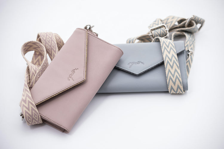 Cowhide leather phone pouch with perforated finish and compact everyday design.