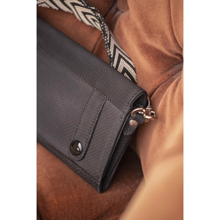 Crossbody equestrian phone pocket with geometric patterned shoulder strap.