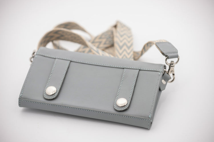 Crossbody phone bag with removable shoulder strap and practical belt attachment loops.