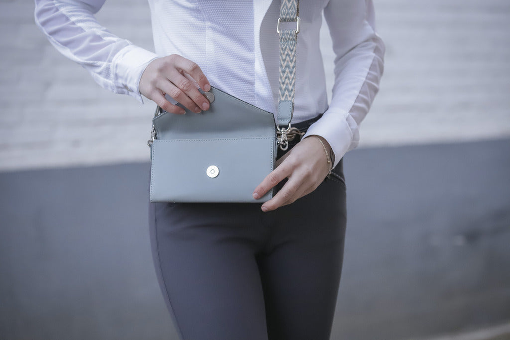 Equestrian leather phone pocket with two rear loops for secure attachment to a belt.