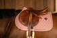 Equestrian saddle pad with elegant plaited glitter binding and cushioning