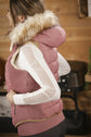 Equestrian vest with removable faux fur for versatile winter wear.