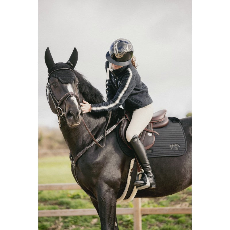Faux fur jump saddle pad with soft lining beneath the saddle and around the withers.