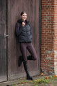 Horse rider wearing Kingsland checked breeches in plum