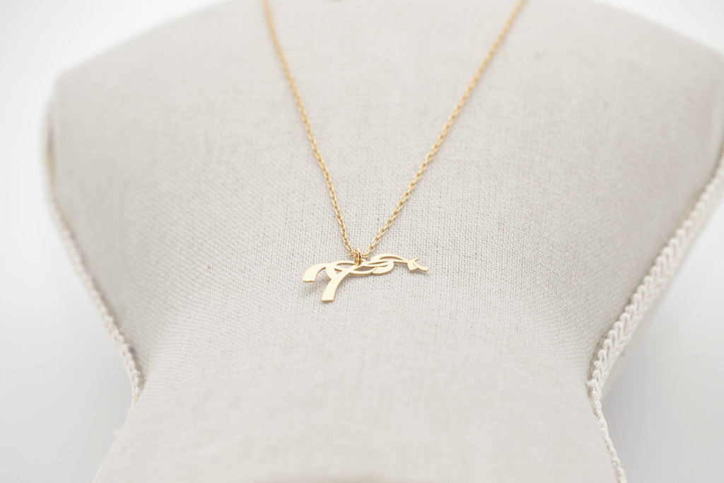 Gold horse pendant necklace with a fine chain for subtle everyday equestrian style.