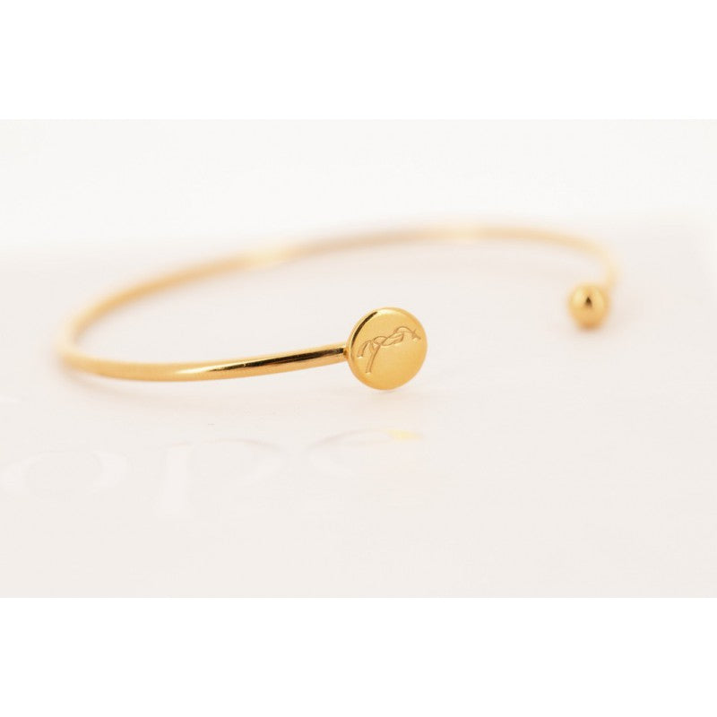 Penelope Collection gold bracelet with signature horse motif and minimalist design.