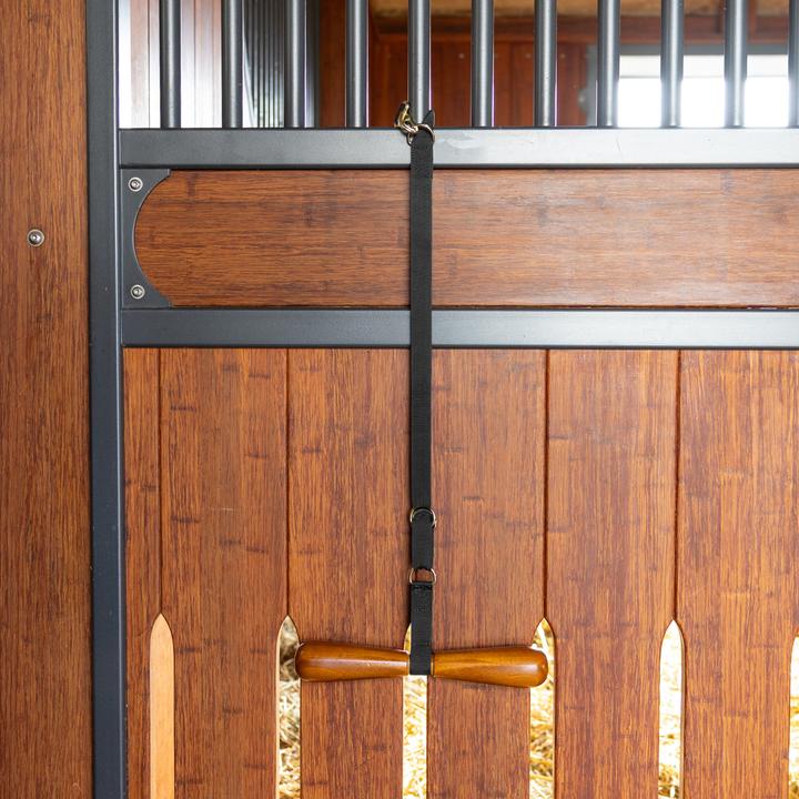 Horse saddle holder with varnished wooden bar for secure saddle support.