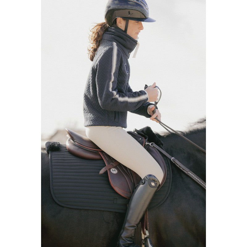 Horse saddle pad with soft faux fur designed for additional comfort under the saddle.