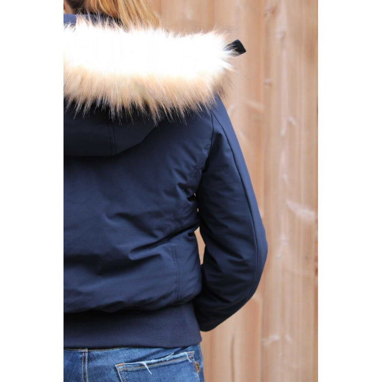 Insulated horse riding jacket for women during cold winter weather.