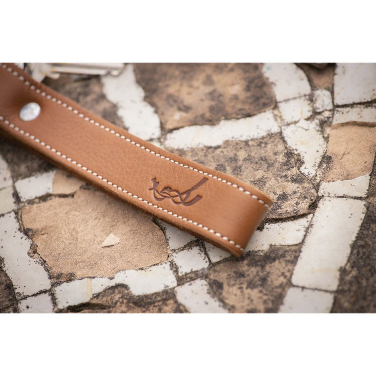 Leather equestrian keychain with elegant saddle stitch detailing.