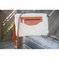 Leather and faux fur crossbody pouch with zip closure and detachable handle for elegant winter styling.