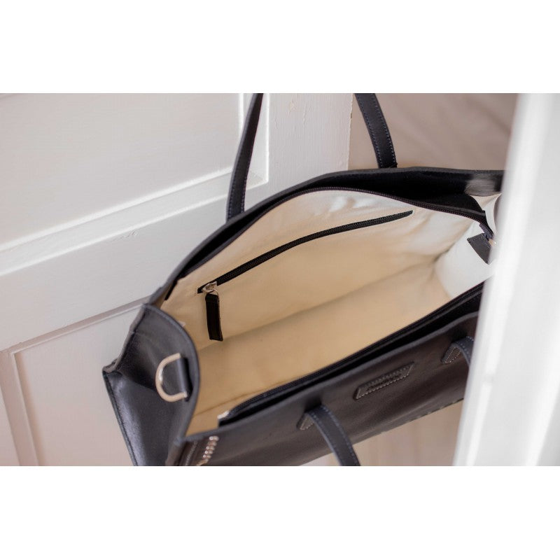 Leather handbag with adjustable strap for shoulder or crossbody wear.