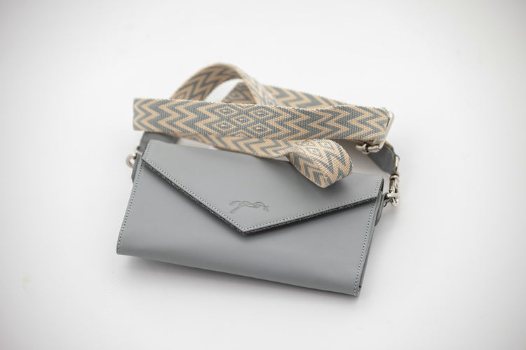 Leather phone bag for riding designed to keep a mobile phone conveniently within reach.
