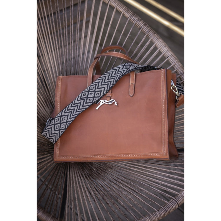 Leather tote bag for women with handles for carrying by hand or on the arm.