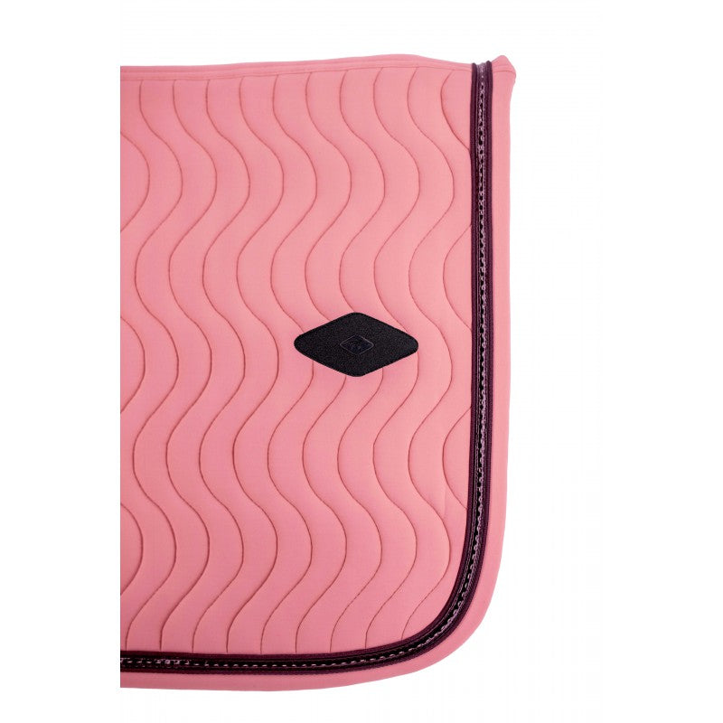 Padded equestrian saddle pad with girth loops for a secure fit during everyday riding.