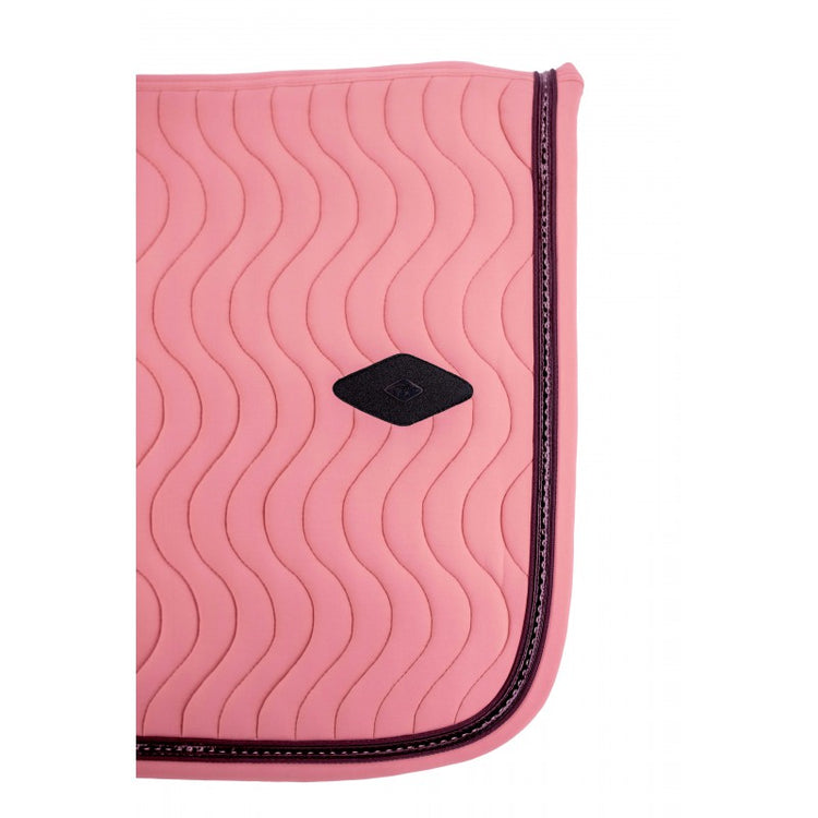 Padded equestrian saddle pad with girth loops for a secure fit during everyday riding.