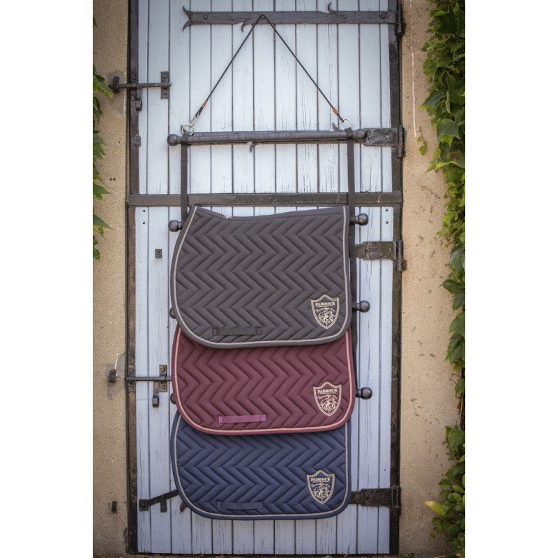 Saddle pad storage rack with removable hanging strap