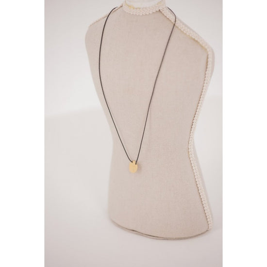 Penelope Adelya Necklace with signature horse logo on a delicate round pendant