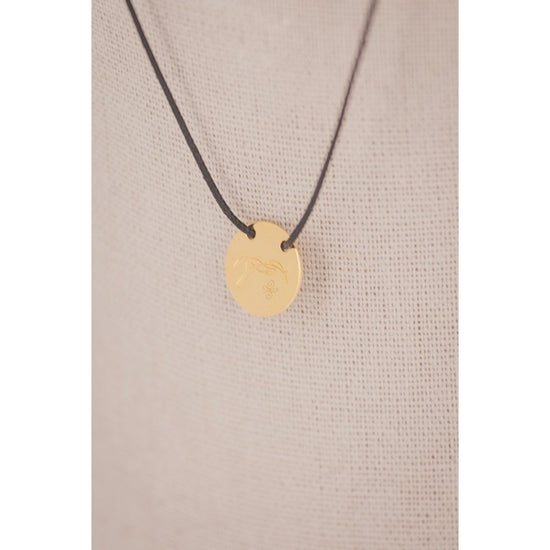 Penelope Adelya pendant necklace with a small round horse logo detail.