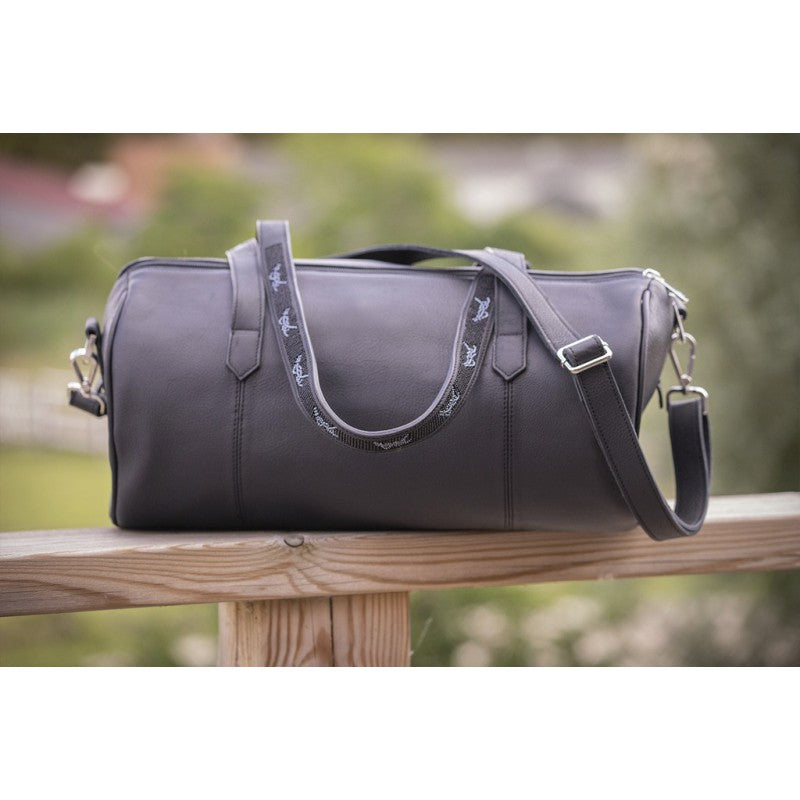 Penelope Bowl leather travel bag with star-shaped logo patch.