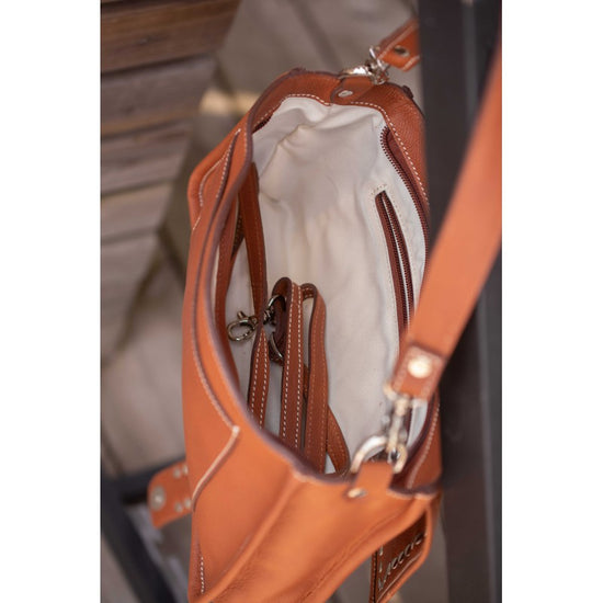 Penelope Cavalia crossbody bag with detachable long strap and embossed signature logo.