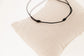 Penelope Collection gold cord bracelet with signature horse logo on a round plate.