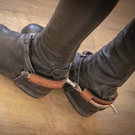 Penelope Collection Spur Covers made from leather with embossed equestrian logo.