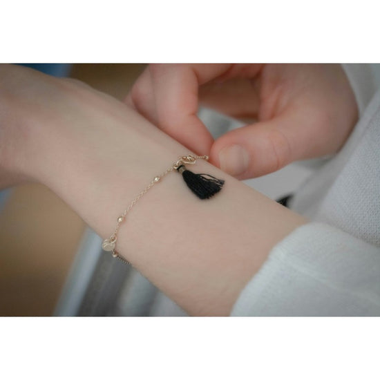 Penelope Eugénie equestrian bracelet with elegant gold details and black pompom at the clasp.
